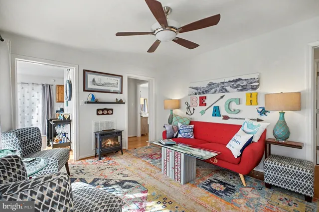 a living room with furniture a red rug and a fireplace