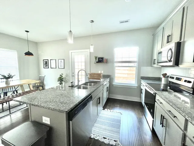 a kitchen with granite countertop lots of counter top space and stainless steel appliances