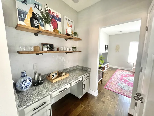 a living room with hard wood flooring and a couch
