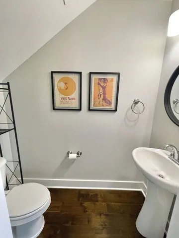 a white toilet sitting next to a bathroom sink and tub