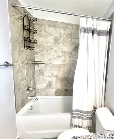 a bathroom with a shower and a toilet