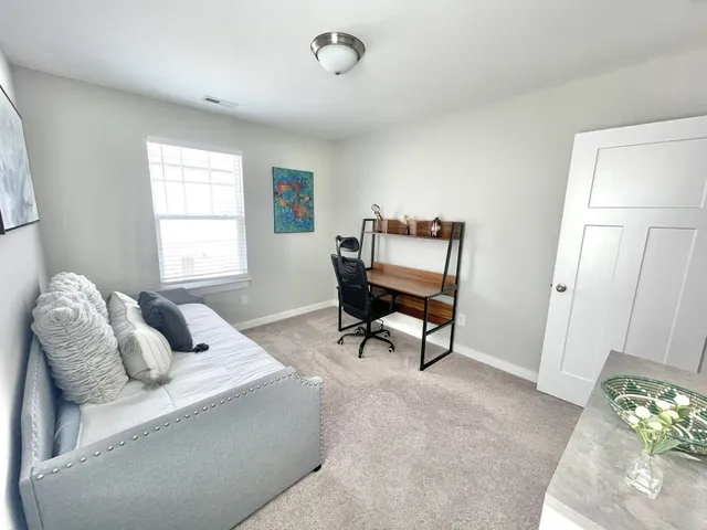 a bedroom with furniture and a window