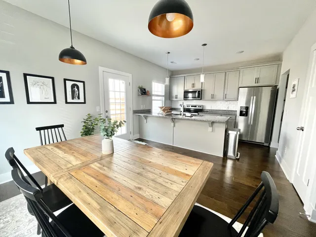 a kitchen with stainless steel appliances granite countertop a stove refrigerator and cabinets