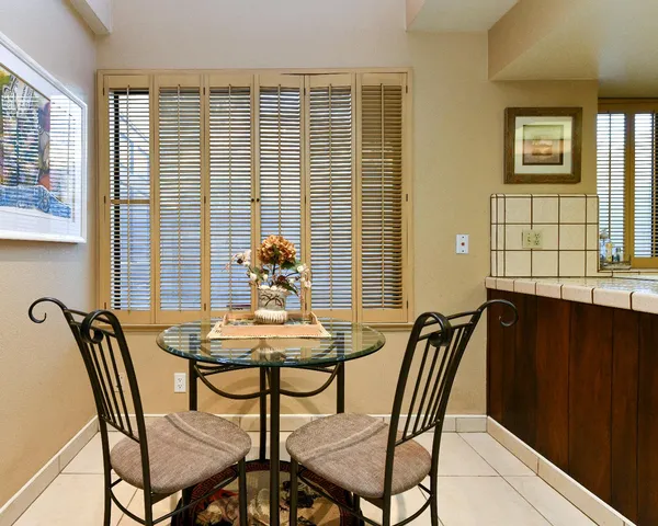 a view of a dining room with furniture and window