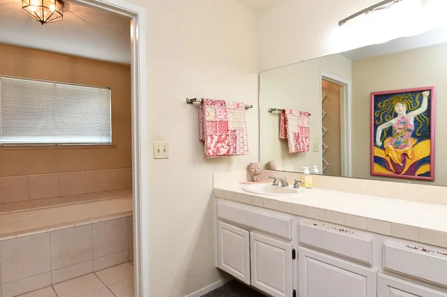 a bathroom with a sink a vanity and a mirror