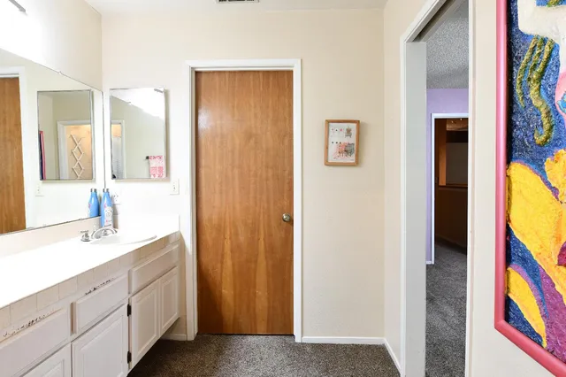 a spacious bathroom with a double vanity sink and a mirror