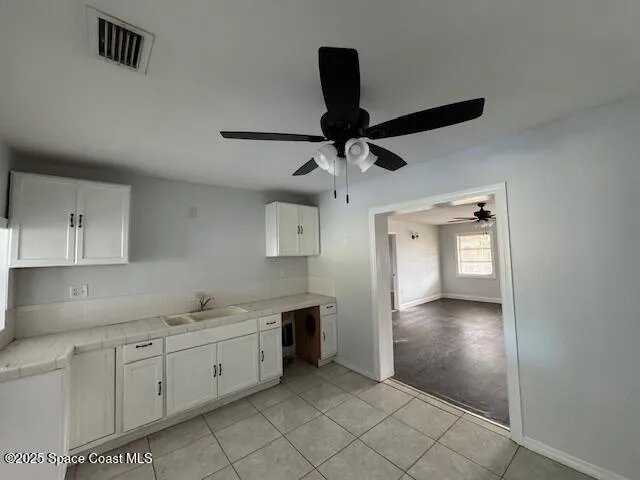a large kitchen with cabinets and wooden floor