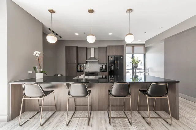 a large kitchen with a table and chairs
