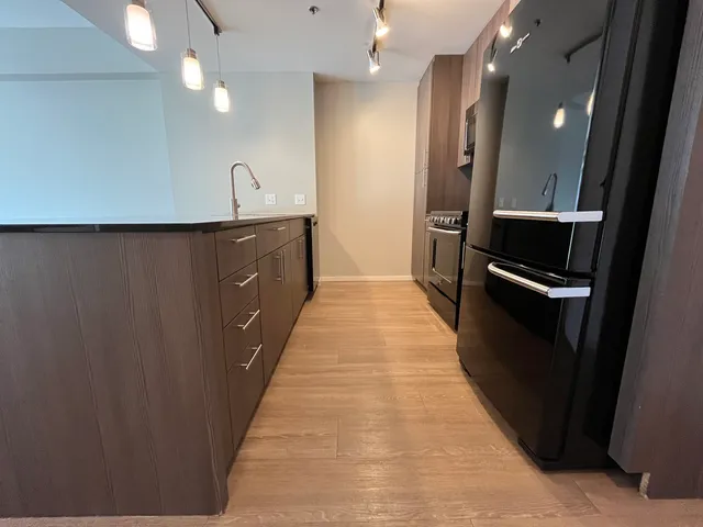 a view of a hallway with wooden floor