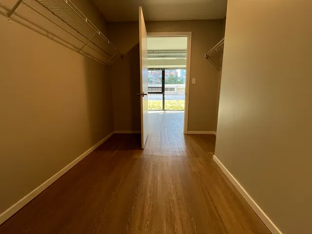 a view of a room with wooden floor and brick walls