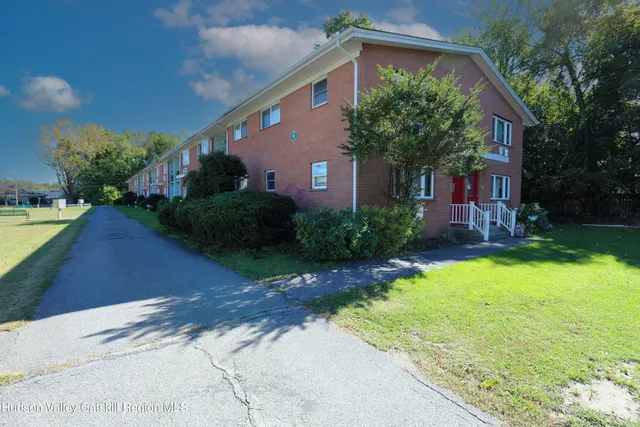 a view of swimming pool with a yard and wooden fence