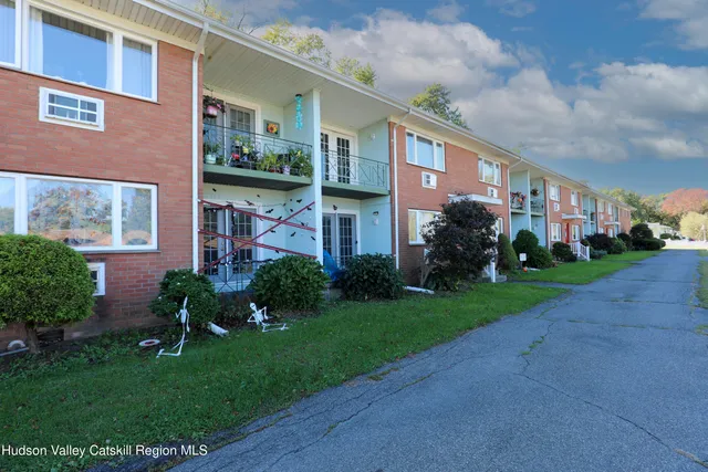 a view of a brick building next to a yard