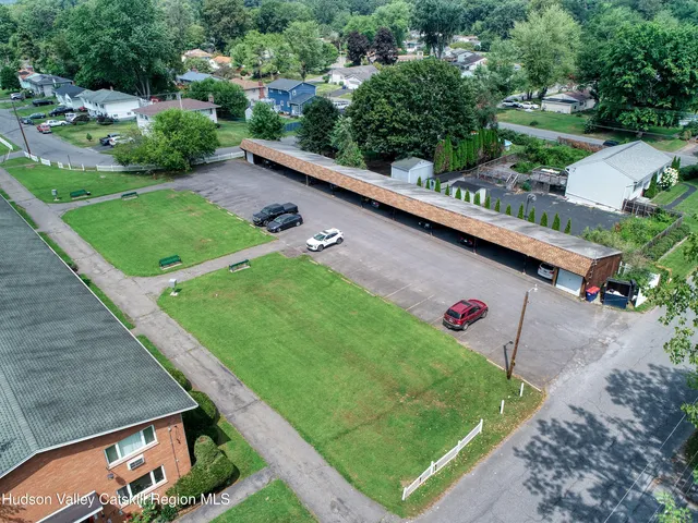 an aerial view of a house with a yard and lake view