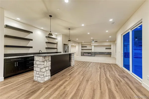 a large kitchen with stainless steel appliances kitchen island granite countertop a stove and a sink