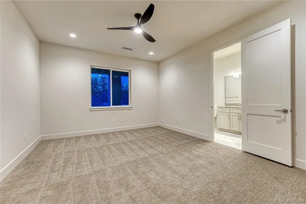 an empty room with closet and windows