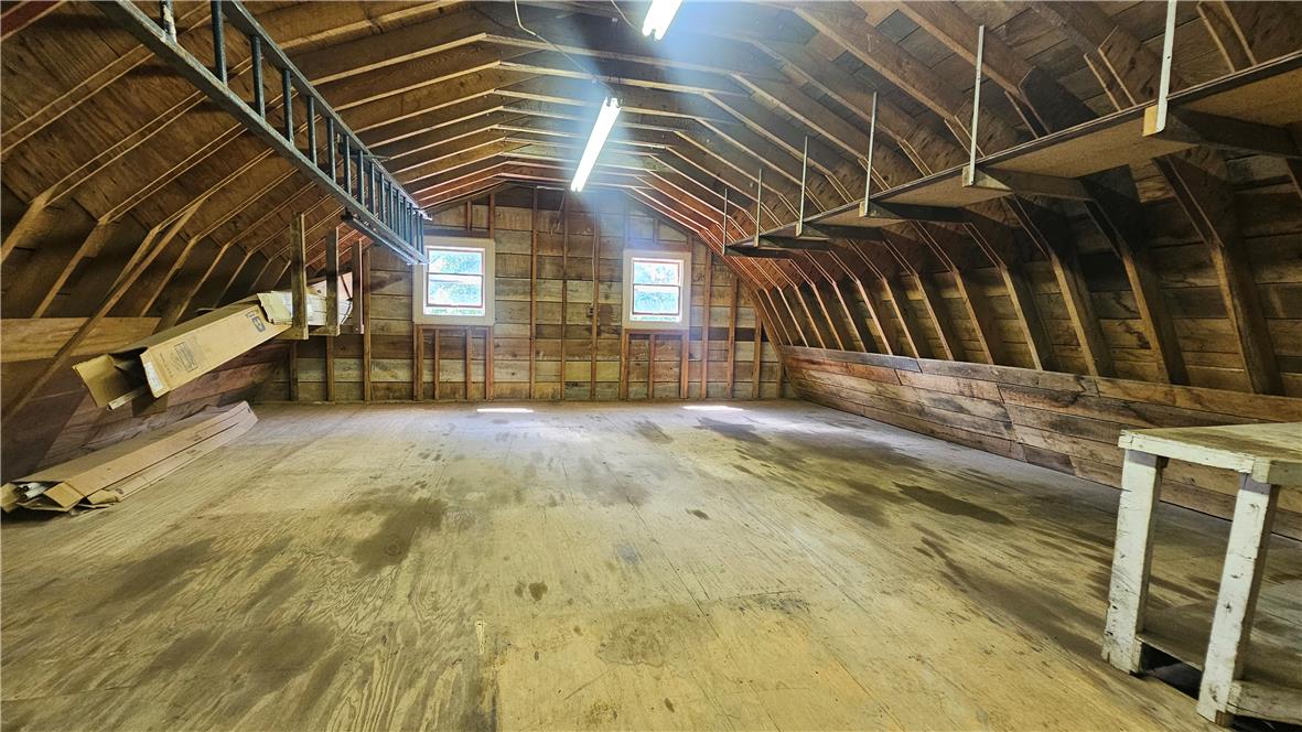 2529 Ringhoffer Road Hellertown, PA 18055 - Photo 25 of 33 A spacious attic area with exposed wooden beams and dual windows awaits transformation.