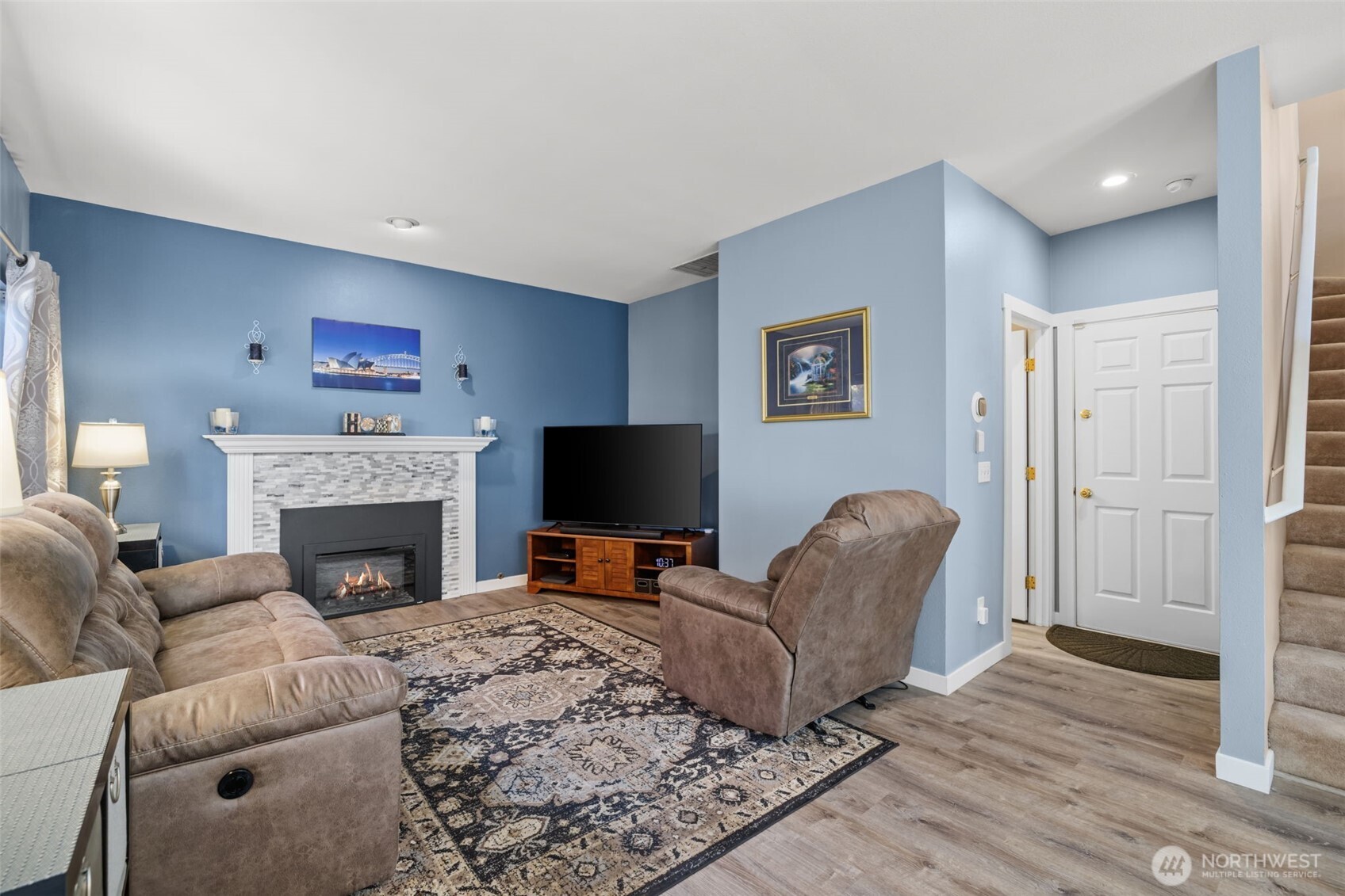 5021 South 232nd Street, Unit 75 Kent, WA 98032 - Photo 13 of 40 a living room with furniture a fireplace and a flat screen tv