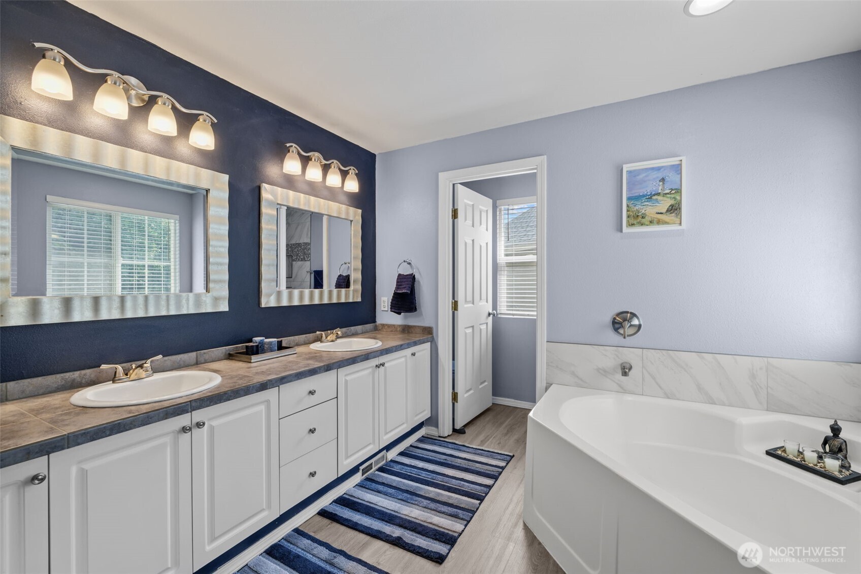 5021 South 232nd Street, Unit 75 Kent, WA 98032 - Photo 22 of 40 a spacious bathroom with a double vanity sink a mirror and a bathtub