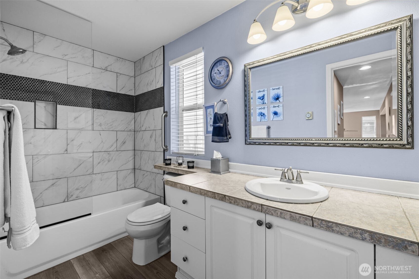 5021 South 232nd Street, Unit 75 Kent, WA 98032 - Photo 28 of 40 a bathroom with a sink toilet a mirror and shower