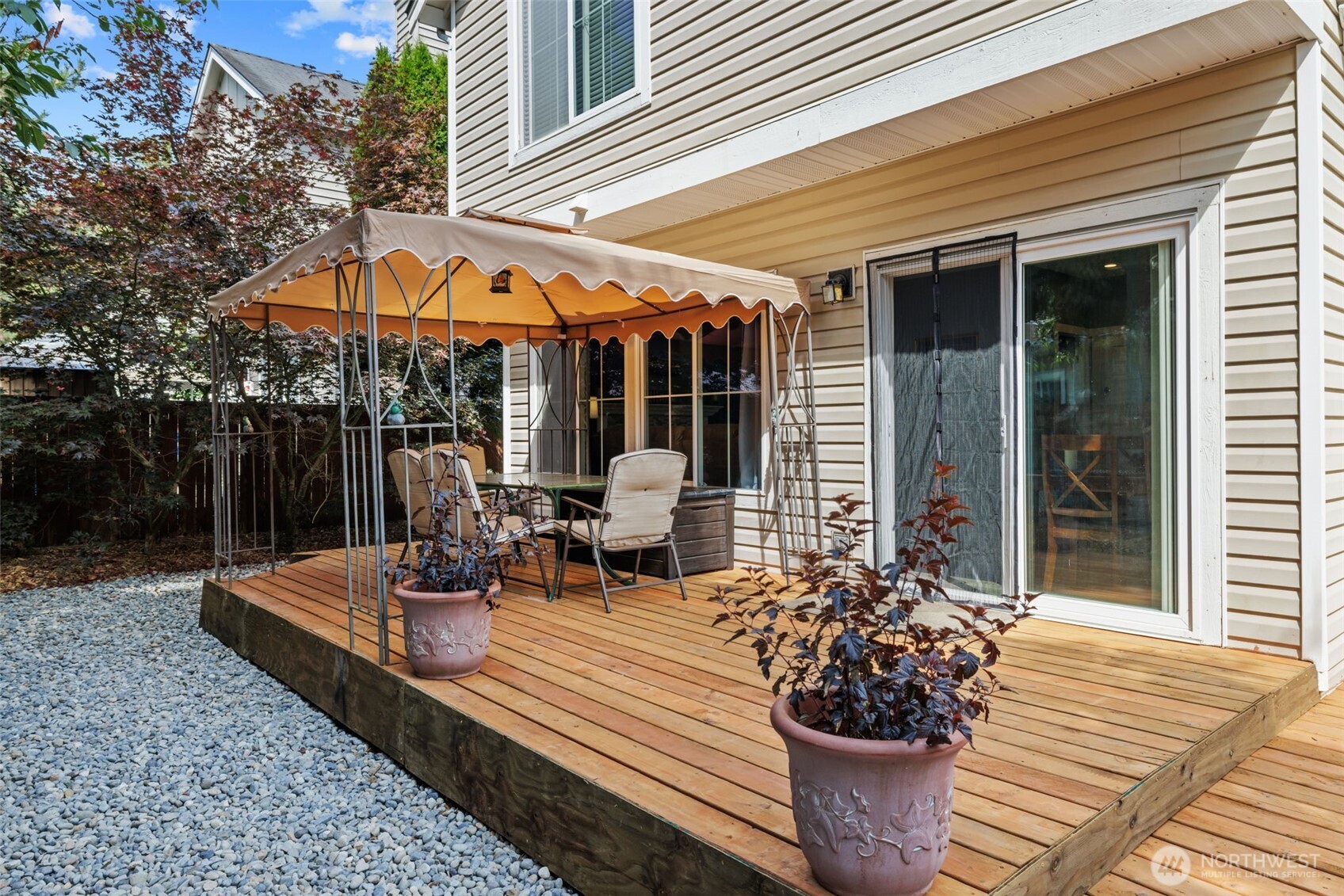 5021 South 232nd Street, Unit 75 Kent, WA 98032 - Photo 32 of 40 a view of a patio with table and chairs under an umbrella