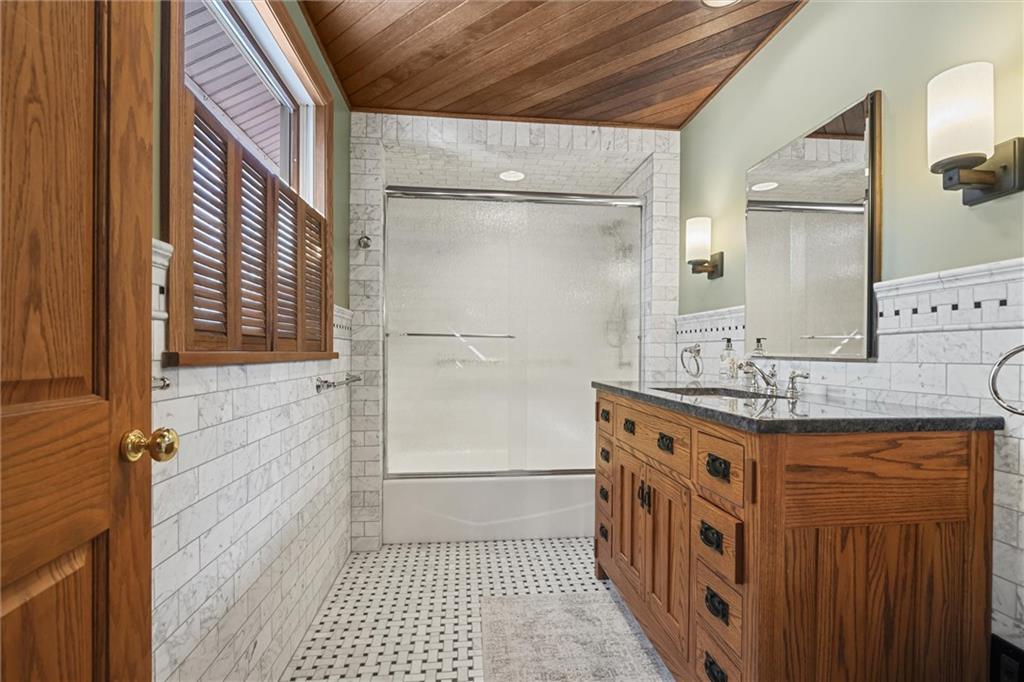 121 Brewer Road Saxonburg, PA 16056 - Photo 25 of 50 a bathroom with a granite countertop sink a mirror and a shower