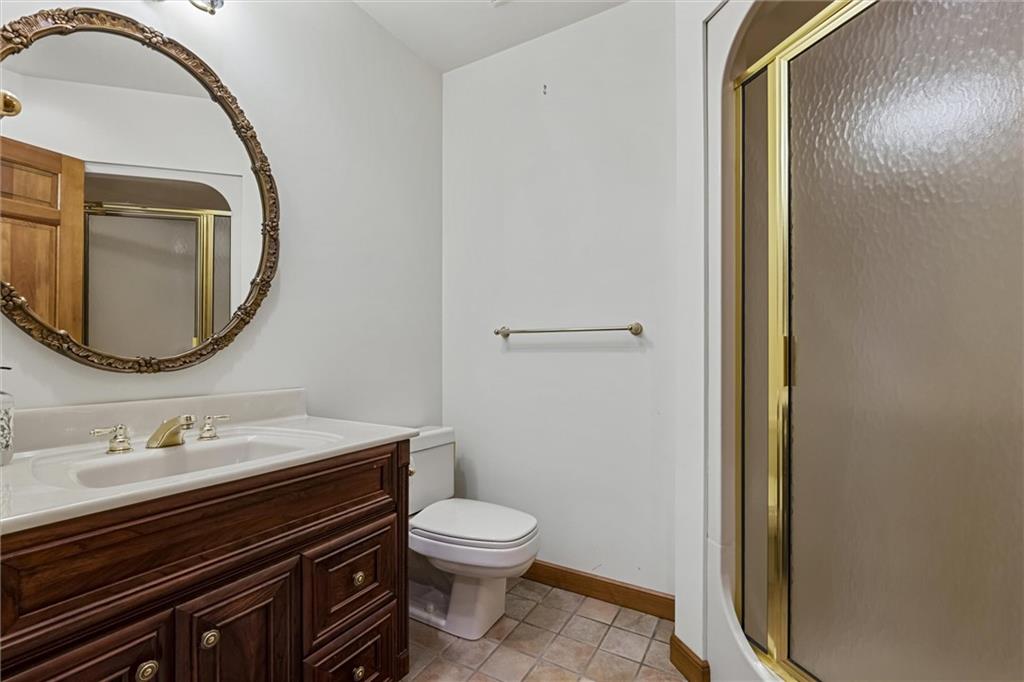 121 Brewer Road Saxonburg, PA 16056 - Photo 31 of 50 a bathroom with a sink a toilet and a mirror