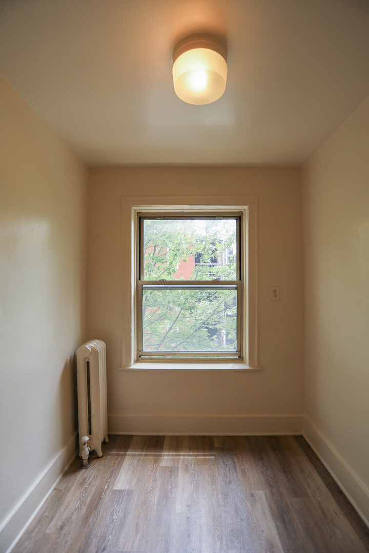 1100 West Roscoe Street, Unit 13 Chicago, IL 60657 - Photo 3 of 9 a view of room with window and hardwood floor