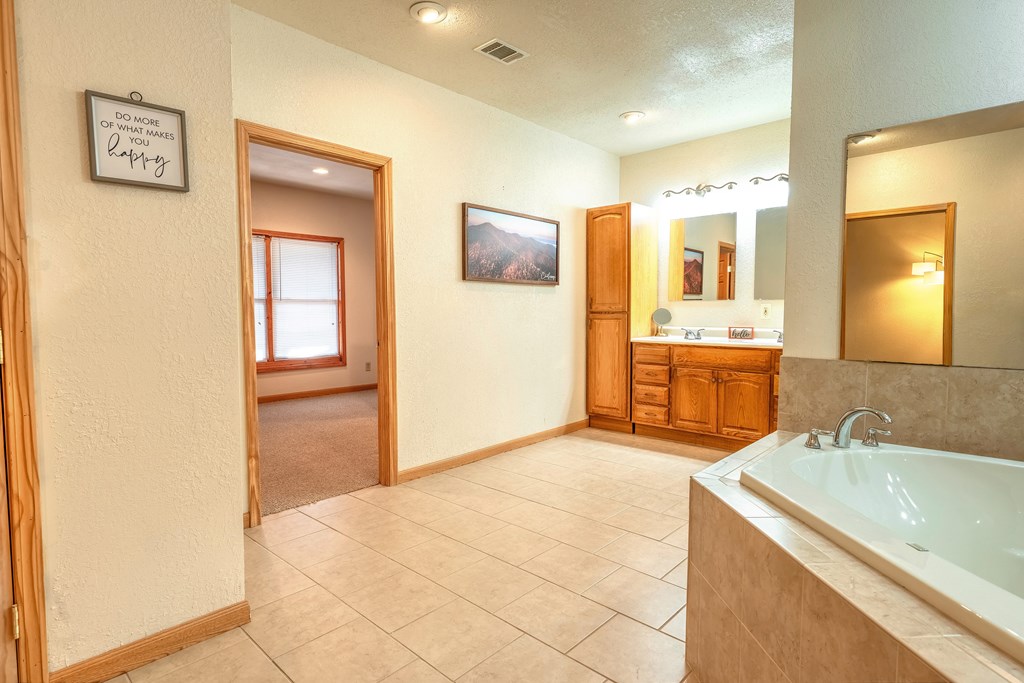 314 Ruby Ridge Young Harris, GA 30582 - Photo 28 of 39 a spacious bathroom with a tub sink and mirror
