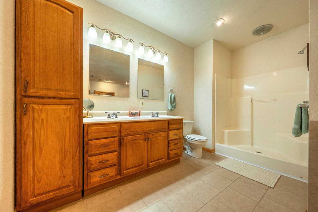 314 Ruby Ridge Young Harris, GA 30582 - Photo 29 of 39 a bathroom with a double vanity sink toilet and shower