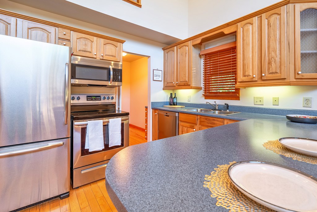 314 Ruby Ridge Young Harris, GA 30582 - Photo 7 of 39 a kitchen with stainless steel appliances granite countertop a sink a stove and a refrigerator