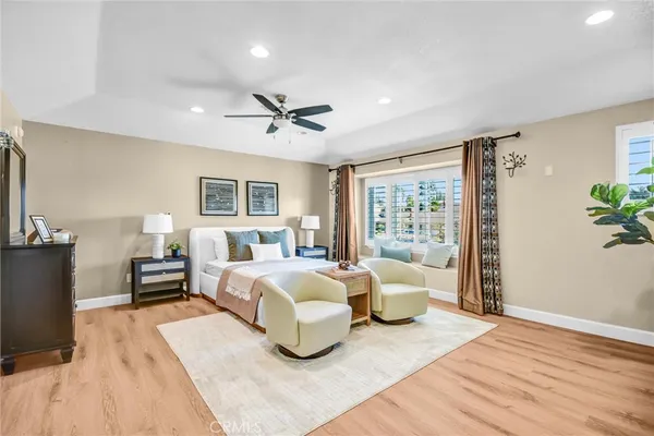 a bedroom with a large bed and a chandelier