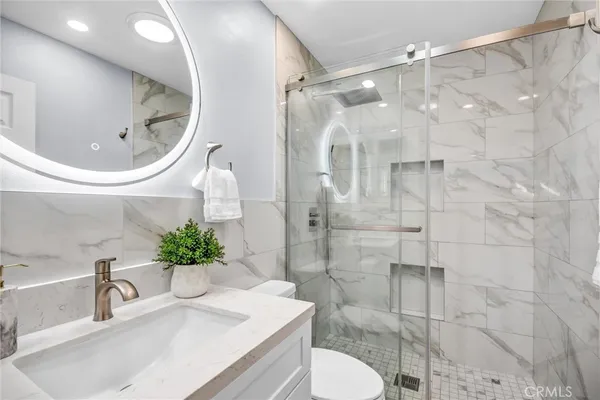 a bathroom with a sink toilet and shower