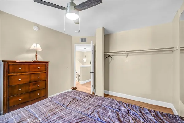 a view of a bedroom with closet and wooden floor