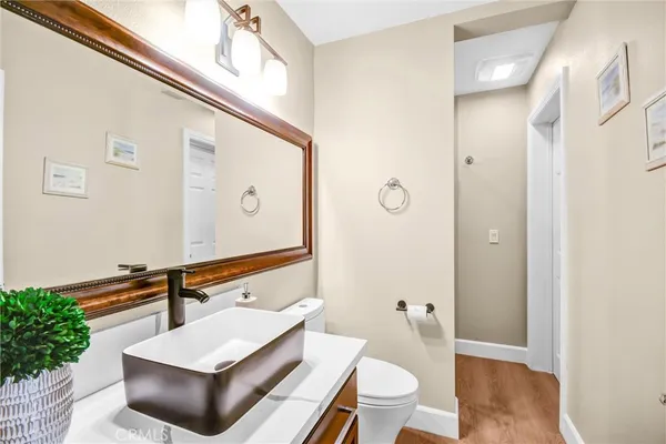 a bathroom with a sink a toilet and a shower