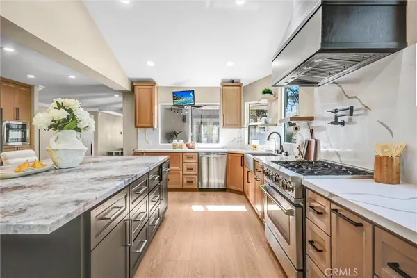 a kitchen with stainless steel appliances granite countertop a stove and a sink