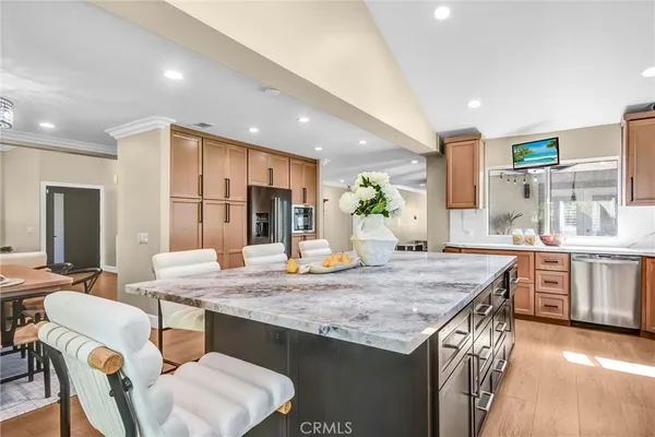a kitchen with center island table and chairs