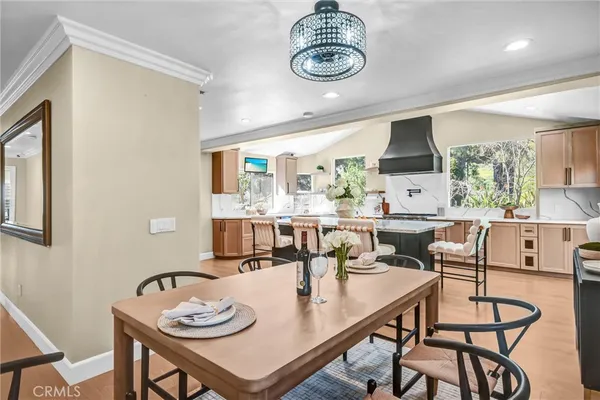 a dining room with furniture a rug and a large window