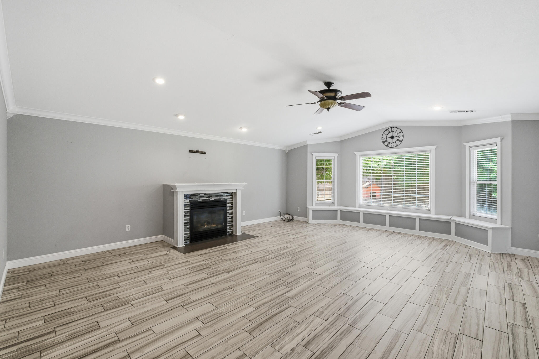618 Birdsong Court Exeter, CA 93221 - Photo 15 of 62 an empty room with windows and a fireplace