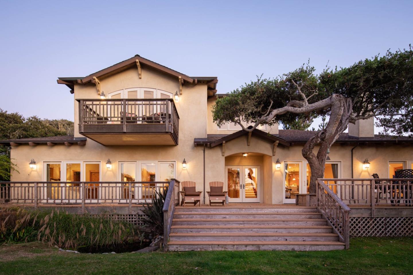 a view of a house with a small yard and floor to ceiling window