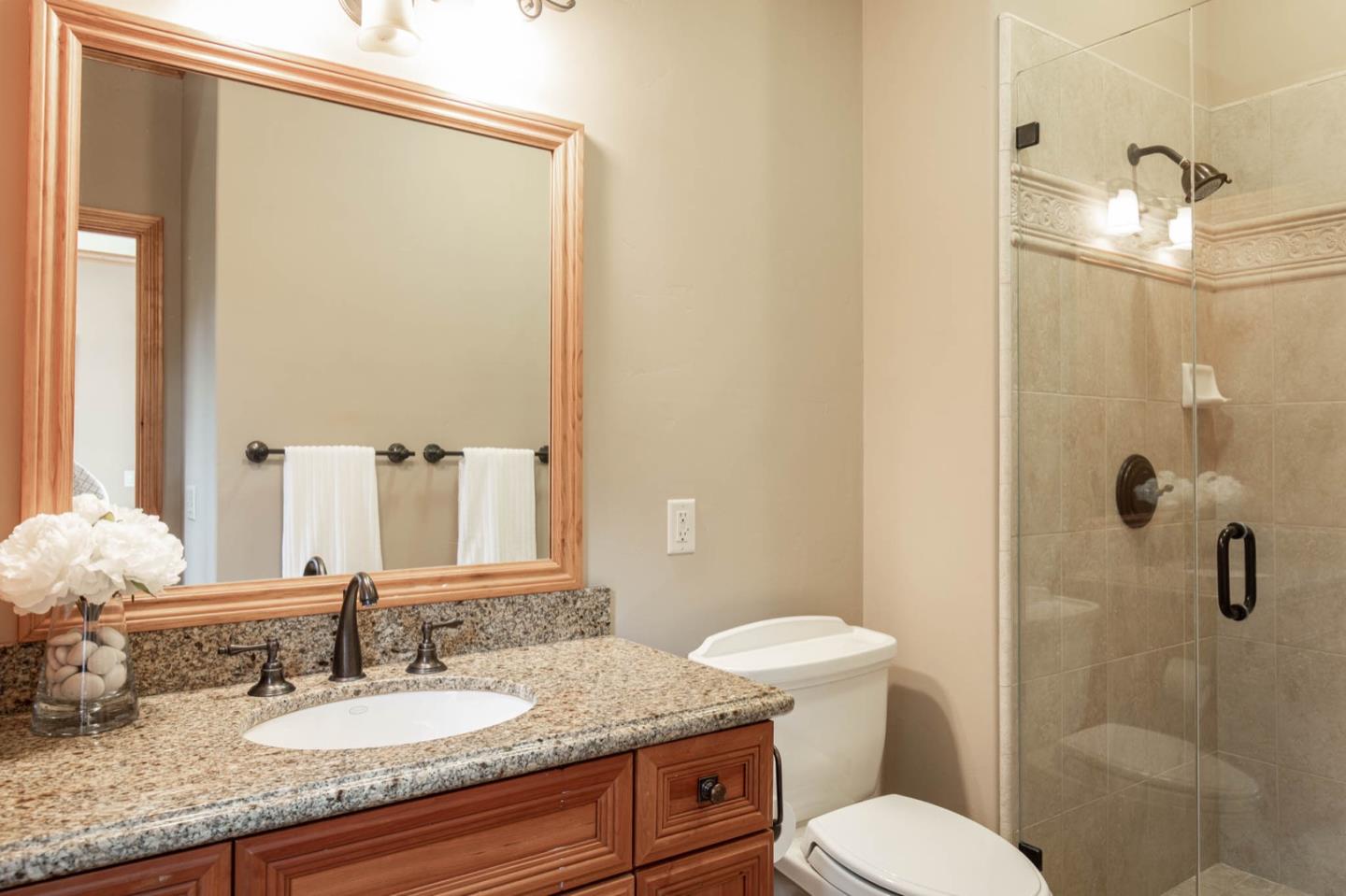 2876 Oak Knoll Road Pebble Beach, CA 93953 - Photo 11 of 14 a bathroom with a granite countertop sink toilet and shower