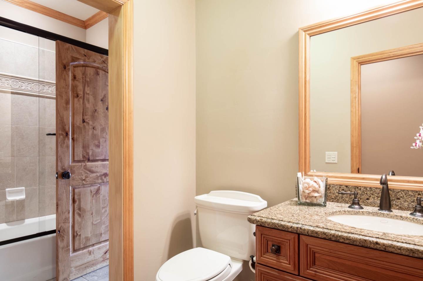 2876 Oak Knoll Road Pebble Beach, CA 93953 - Photo 13 of 14 a bathroom with a granite countertop sink toilet and shower