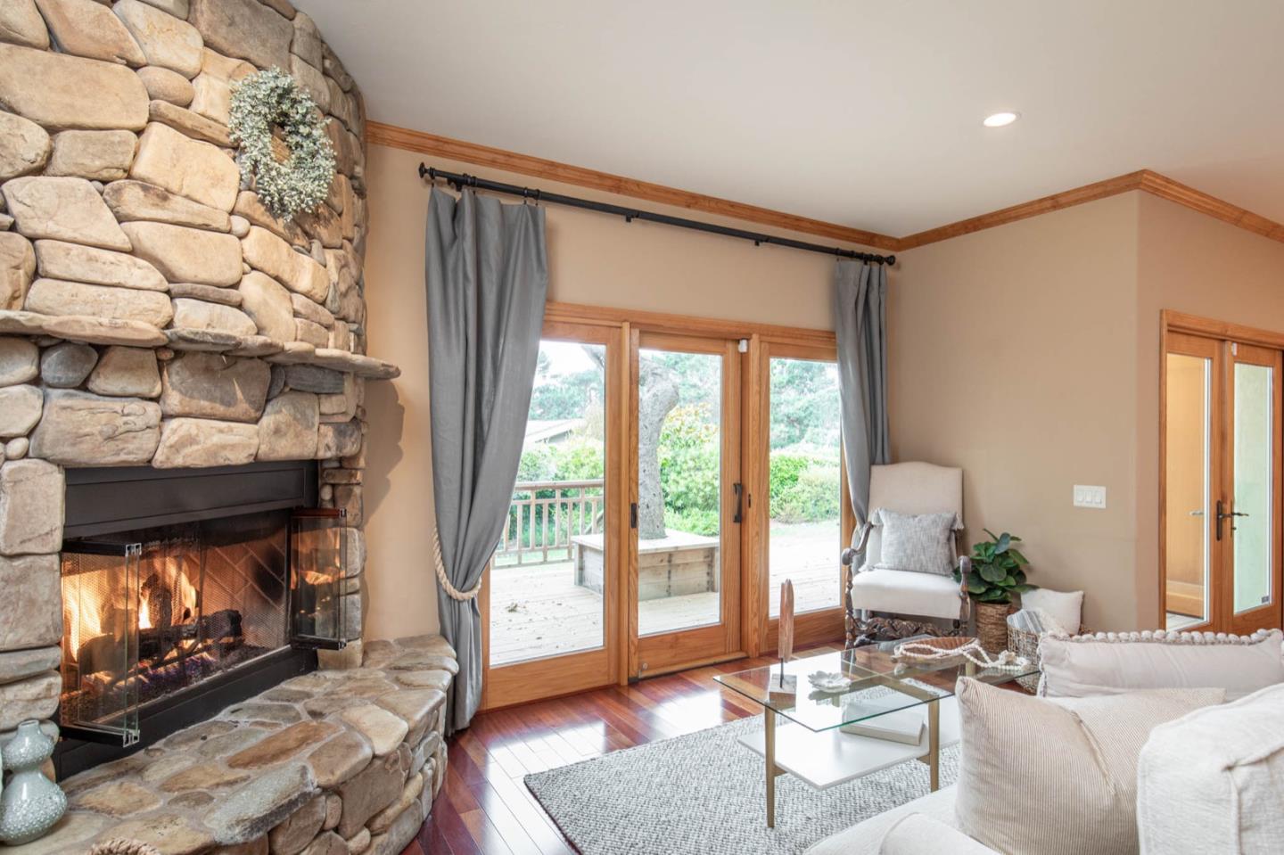 2876 Oak Knoll Road Pebble Beach, CA 93953 - Photo 5 of 14 a living room with furniture a fireplace and a floor to ceiling window
