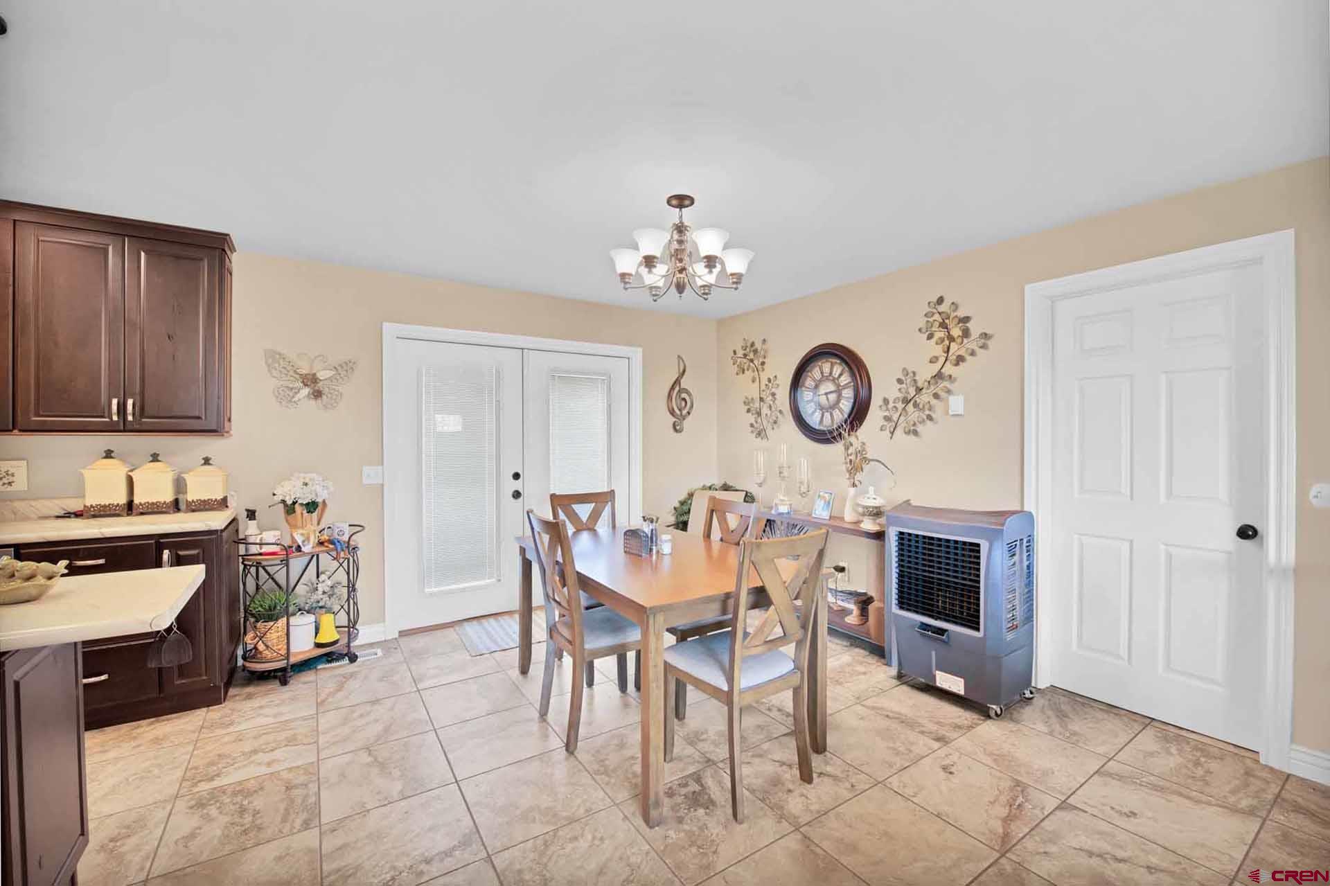 10487 2100th Road Austin, CO 81410 - Photo 11 of 35 a view of a dining room with furniture and a clock