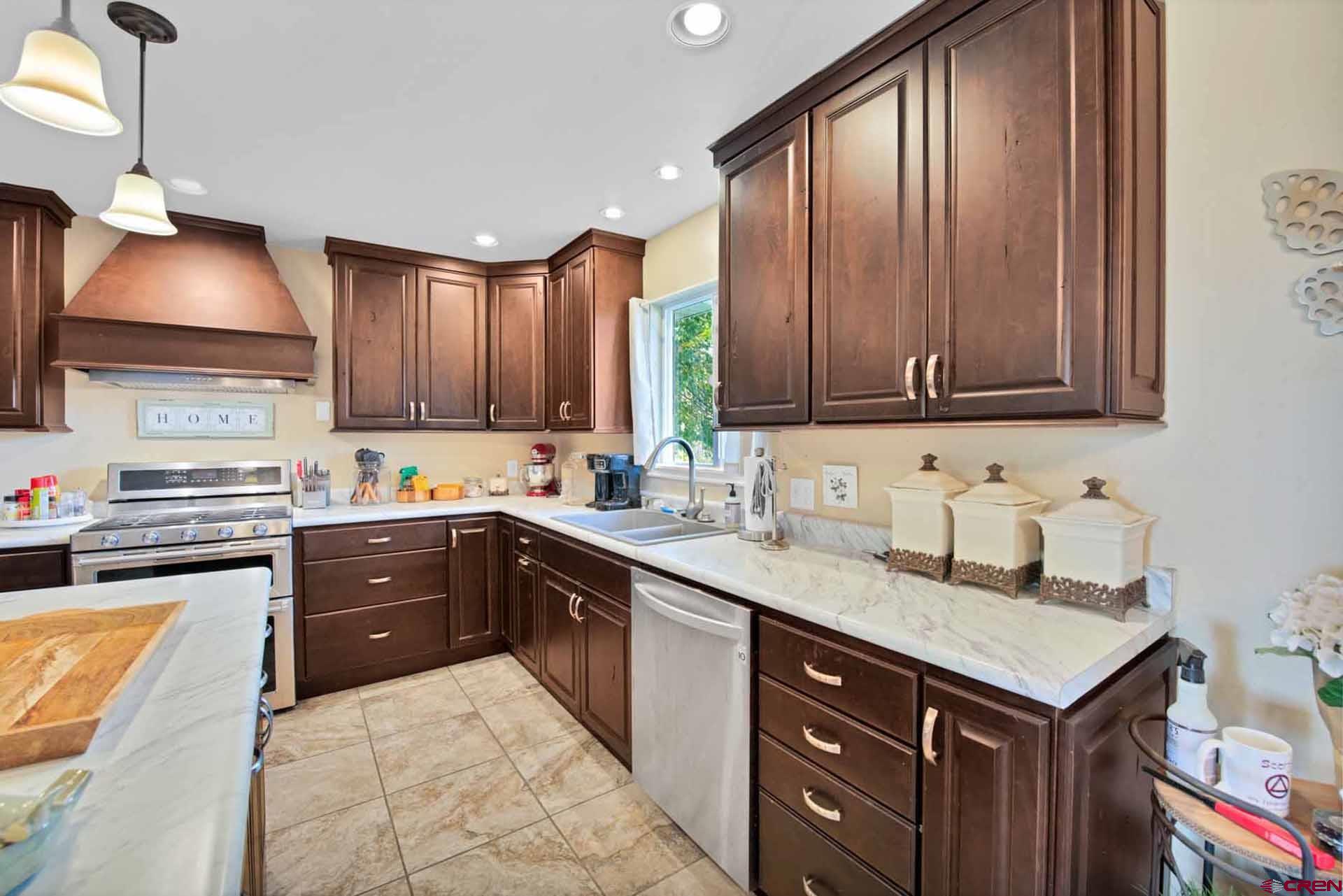 10487 2100th Road Austin, CO 81410 - Photo 15 of 35 a kitchen with a stove a sink and a refrigerator