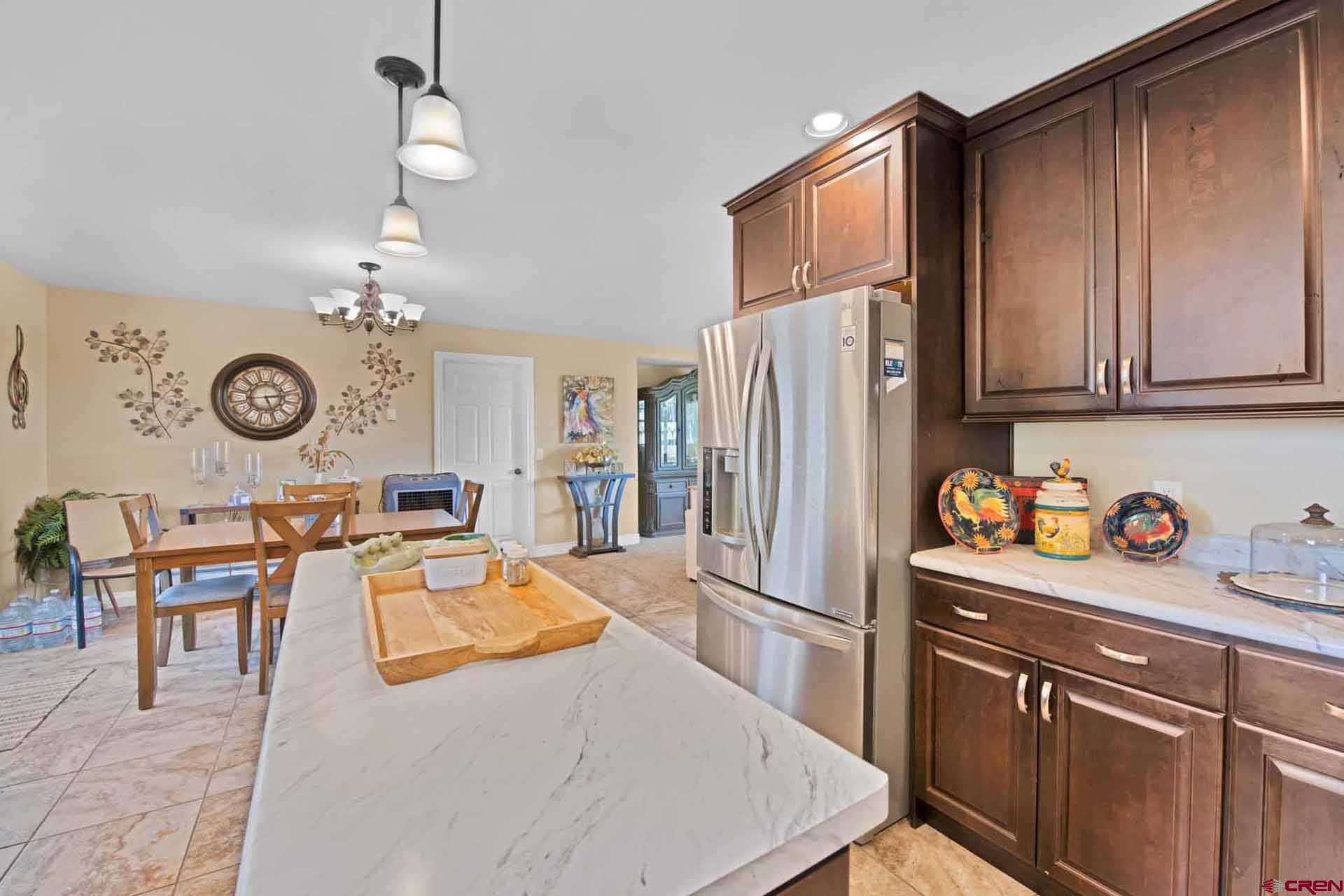10487 2100th Road Austin, CO 81410 - Photo 17 of 35 a kitchen with stainless steel appliances granite countertop a refrigerator a stove and a sink with cabinets