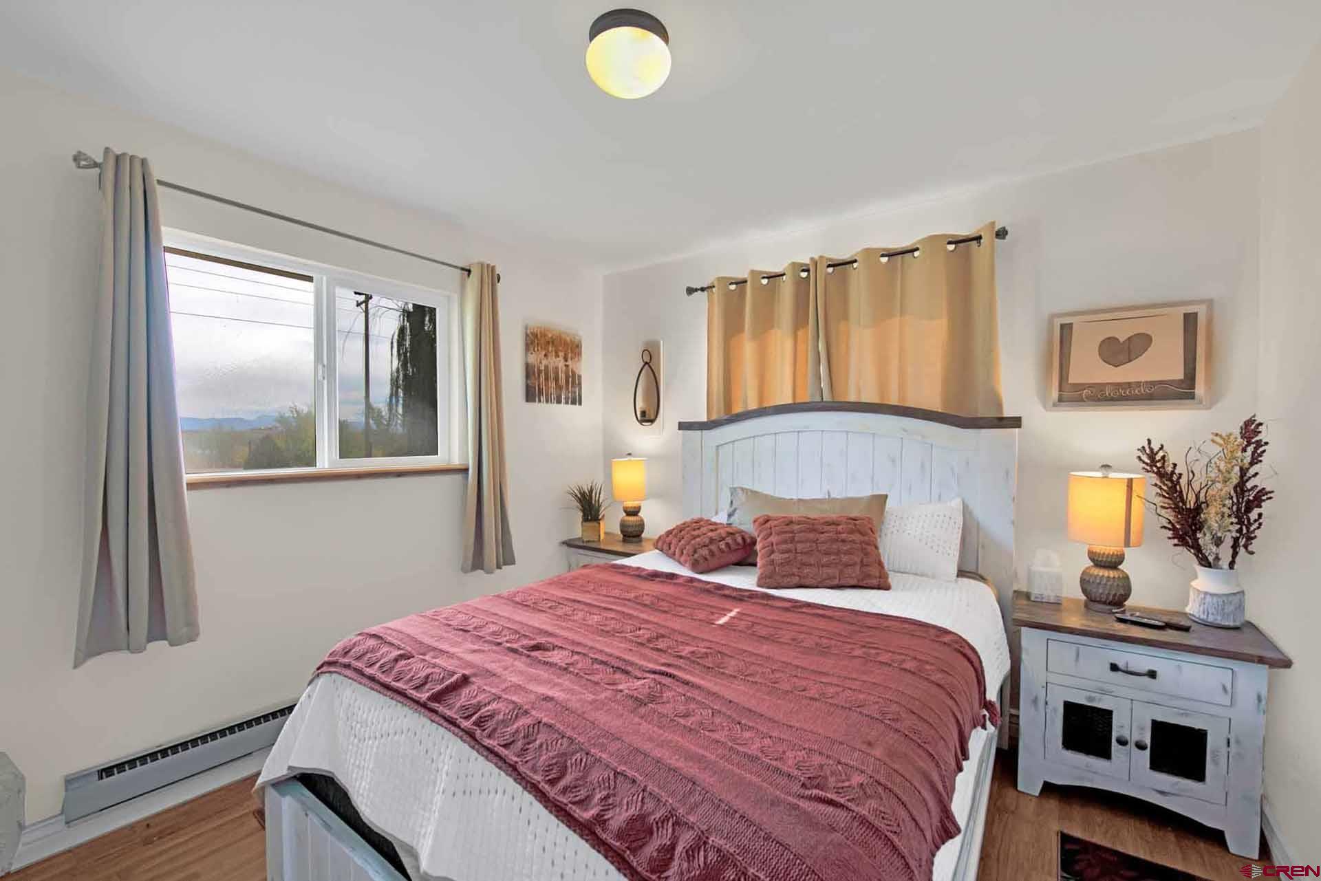 10487 2100th Road Austin, CO 81410 - Photo 27 of 35 a bedroom with a bed and wooden floor