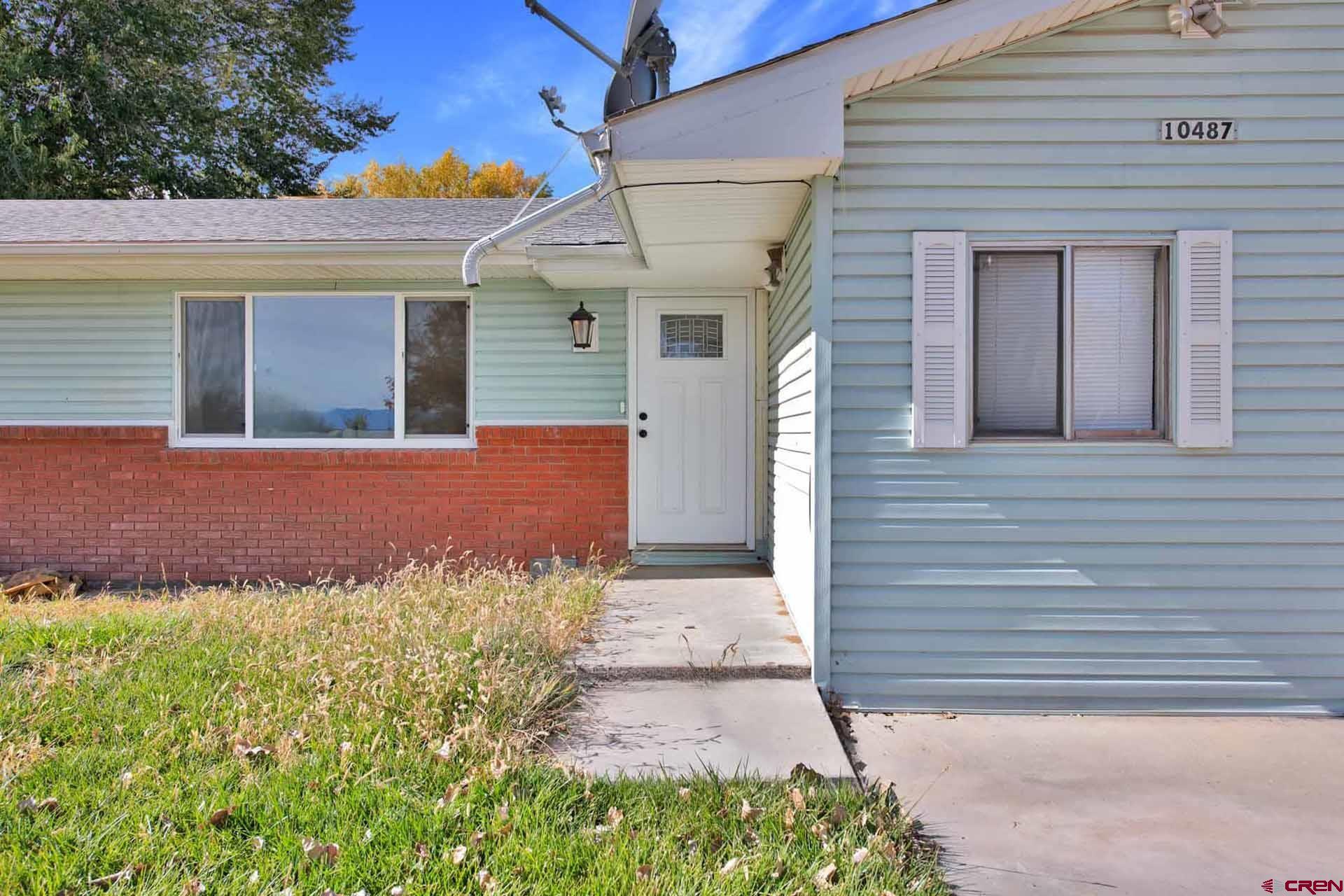 10487 2100th Road Austin, CO 81410 - Photo 4 of 35 a front view of a house with a yard and outdoor seating