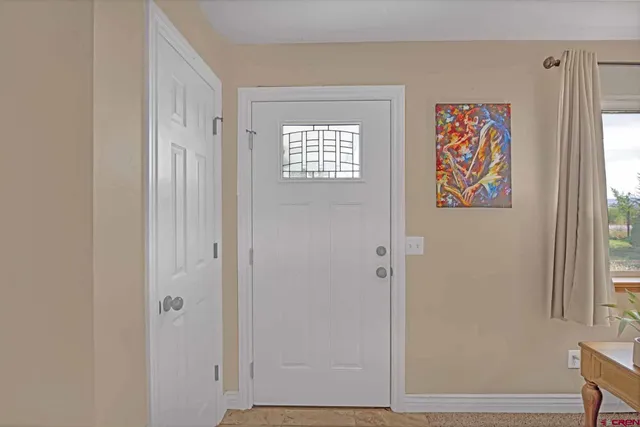 a view of an entryway with wooden floor