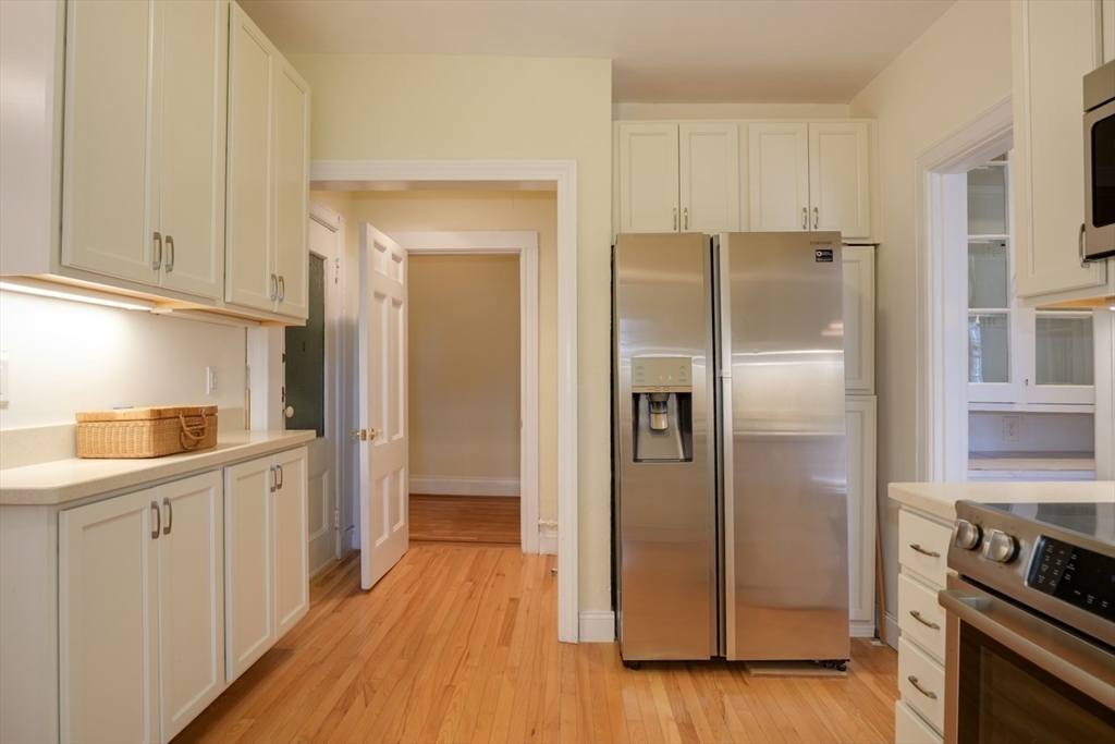 983 Memorial Drive, Unit 502 Cambridge, MA 02138 - Photo 11 of 33 a kitchen with stainless steel appliances a refrigerator and a stove
