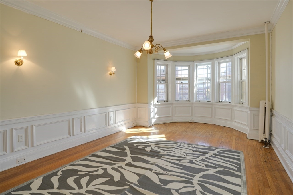 983 Memorial Drive, Unit 502 Cambridge, MA 02138 - Photo 16 of 33 a view of an empty room with window and wooden floor